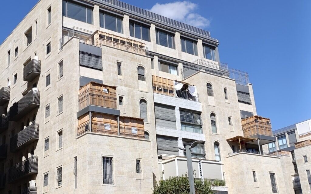 Sukkahs built on designated Sukkah balconies near the Meah Shearim neighborhood in Jerusalem, October 8, 2025 (Zev Stub/Times of Israel)