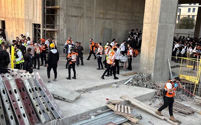 Emergency responders at a construction site in Jerusalem where a teenage boy feel to his death on October 30, 2025, amid a mass Haredi anti-enlistment rally in Jerusalem. (Charlie Summers/Times of Israel)