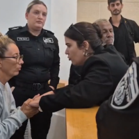 Gaza flotilla activist Reyes Rigo Cervilla (left), accused of attacking a prison guard, appears at a court hearing after accepting a plea bargain with prosecutors, in the Beersheba Magistrate's Court on October 10, 2025. (Screenshot/Ynet)