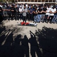Mourners pray over the body of 15-year-old Palestinian Yamen Hamed who was killed by Israeli forces, during his funeral in Silwad, near the city of Ramallah in West Bank on October 31, 2025. (JAAFAR ASHTIYEH / AFP)