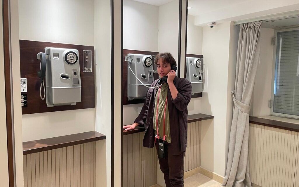 A staffer at one of the original telephones in the Knesset Museum, open since August 2025 (Courtesy)