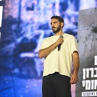 Yonatan Shamriz, brother of hostage Alon Shamriz, who was mistakenly killed by IDF troops in Gaza in December 2023, speaks at the national memorial ceremony in Tel Aviv founded by his organization, Kumu, marking two years since Hamas's October 7, 2023, onslaught, on October 7, 2025. (Oshrit Zinger/Pro-Democracy Protest Movement)