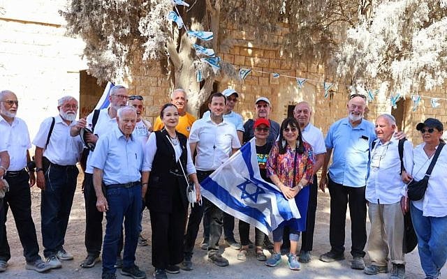 Samaria Regional Council chair Yossi Dagan (with flag) stands with settler activists who marched up to the Sebastia railway station in 1975 to demand the establishment of a civilian settlement in the northern West Bank, October 8, 2025. (Hillel Ben Or)