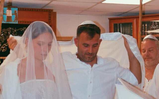 Mika Majzner and Elad Dubnov get married for the second time, at the synagogue of Kibbutz Be’eri in southern Israel, on August 23, 2024. (Courtesy)