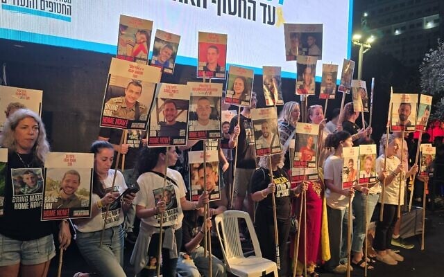 Families of hostages held in Gaza seen on the stage at Hostages Square in Tel Aviv on October 11, 2025, holding posters of their loved ones, who are expected to return home in the coming two days. (Shai Hazan / Pro-Democracy Protest Movement) Families of hostages held in Gaza seen on the stage at Hostages Square in Tel Aviv on October 11, 2025, holding posters of their loved ones, who are expected to return home in the coming two days. (Shai Hazan / Pro-Democracy Protest Movement)