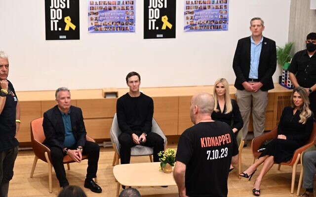 Steve Witkoff, left, and Jared Kushner, second left, listen as Ofir Braslavski speaks in Tel Aviv on October 11, 2025. (Paulina Patimer/Hostages Families Forum Headquarters)