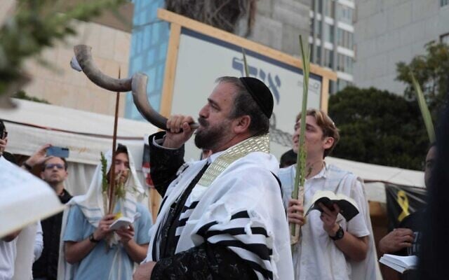 Worshippers conduct a morning prayer service on the holiday of Hoshanna Rabba, the final day of the Sukkot festival, as they await the return of 20 living hostages at Hostages Square in Tel Aviv on October 13, 2025 (Lizzy Shaanan/Israeli Pro-Democracy Protest Movement)
