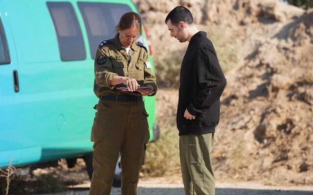 Released hostage Guy Gilboa-Dalal is seen meeting with an IDF officer in the Gaza Strip shortly after being freed from Hamas captivity on October 13, 2025 (Courtesy)