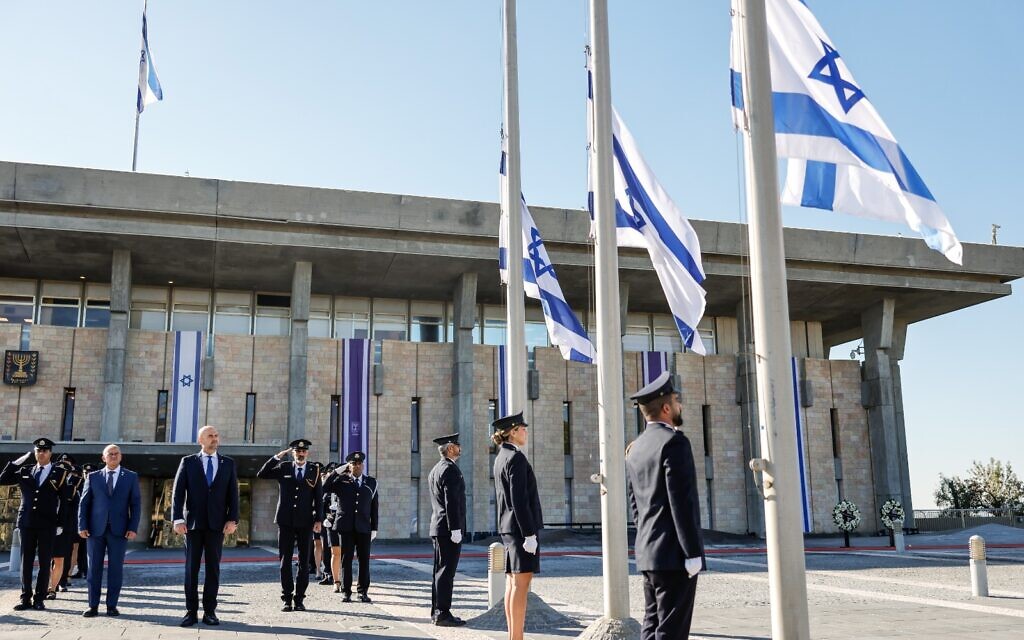The Knesset Honor Guard lowers flags to half mast on October 16, 2025. (Noam Moskowitz, Office of the Knesset Spokesperson)