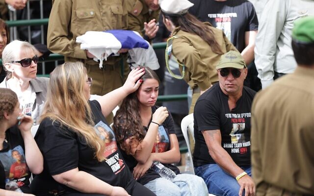 Herut Nimrodi, left, daughter Mika Nimrodi, and Alon Nimrodi mourn at the funeral of their son and brother, Tamir Nimrodi, October 16, 2025, at the Kfar Saba military cemetery. (Credit Alon Gilboa/Hostages Forum)