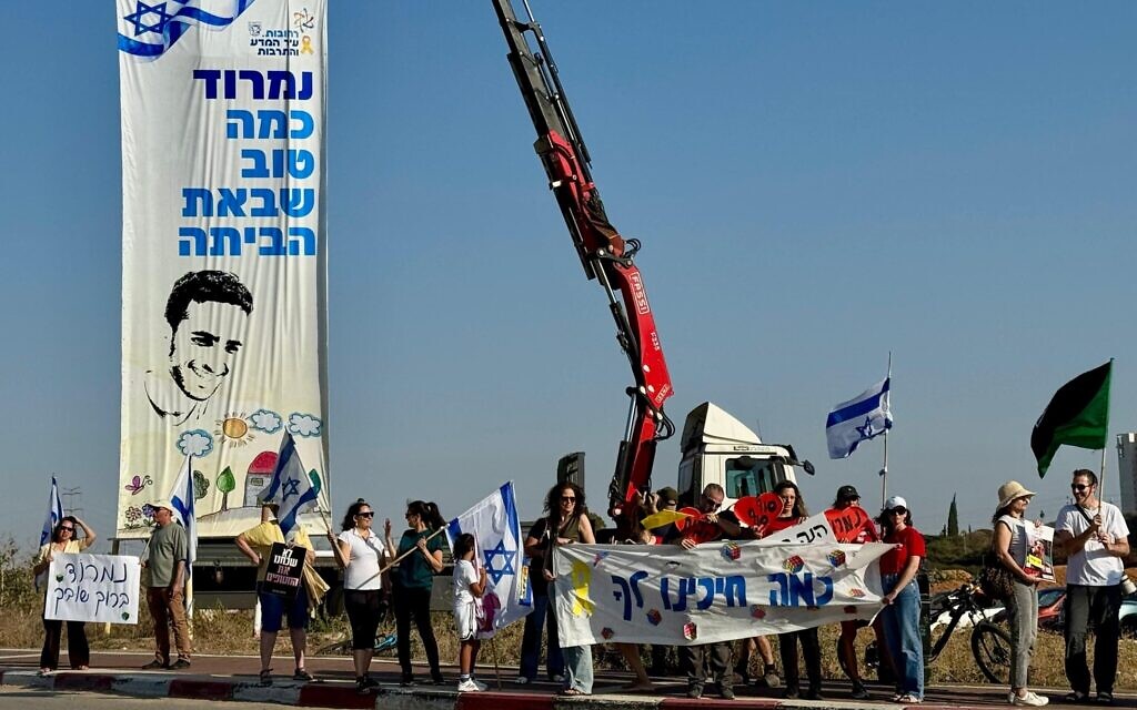 Residents of Rehovot await the return home of released hostage Nimrod Cohen, holding a banner that reads: 'Nimrod, it's so good that you've come home' (Vardit Alon-Korpel/Israeli Pro-Democracy Protest Movement)