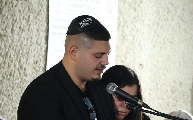 Shahar Levy, son of Eitan Levy, whose body was returned to Israel from Gaza, eulogizes his father on October 16, 2025. (Omer Shusheim/Hostages and Missing Families Forum)