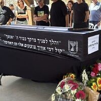 Loved ones gather around the casket of Eliyahu Margalit, at his funeral in Kibbutz Nir Oz on October 20, 2025. Terrorists murdered Margalit on October 7, 2023, and held his body in Gaza for two years. (Hostages and Missing Families Forum)