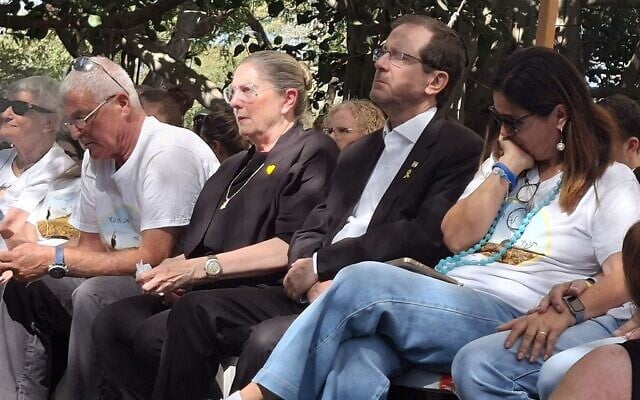 President Isaac Herzog and Michal Herzog, second and third from right, next to Yael Adar, mother of Tamir Adar, at his Kibbutz Nir Oz funeral on October 23, 2025. (Courtesy Hostages Forum) President Isaac Herzog and Michal Herzog, second and third from right, next to Yael Adar, mother of Tamir Adar, at his Kibbutz Nir Oz funeral on October 23, 2025. (Courtesy Hostages Forum)