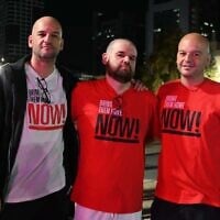 Left to right: The brothers Amos, Eitan, and Iair Horn visit Hostages Square in Tel Aviv, days after Eitan was released from Hamas captivity, on October 25, 2025. (Paulina Patimer/Hostages and Missing Families Forum)