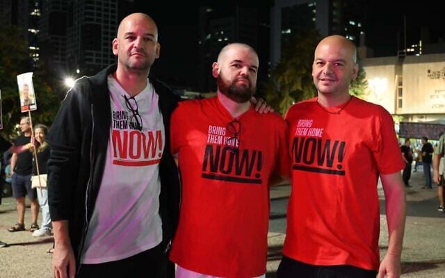 Left to right: The brothers Amos, Eitan, and Iair Horn visit Hostages Square in Tel Aviv, days after Eitan was released from Hamas captivity, on October 25, 2025. (Paulina Patimer/Hostages and Missing Families Forum)