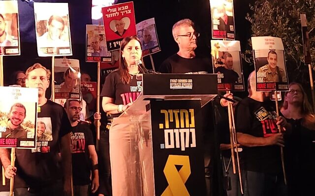 Anat and Hagai Angrest, the parents of freed hostage soldier Matan Angrest, speak at a rally at Hostages Square, in Tel Aviv, where protesters are calling for the release of the final 13 deceased hostages, on October 25, 2025. (Marcelo Sznaidman/Pro-Democracy Protest Movement) Anat and Hagai Angrest, the parents of freed hostage soldier Matan Angrest, speak at a rally at Hostages Square, in Tel Aviv, where protesters are calling for the release of the final 13 deceased hostages, on October 25, 2025. (Marcelo Sznaidman/Pro-Democracy Protest Movement)