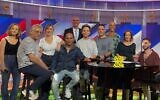 Released hostage Alon Ohel (seated at piano) with the cast of 'Eretz Nehederet' on October 29, 2025. (Courtesy, Keshet)