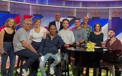 Released hostage Alon Ohel (seated at piano) with the cast of 'Eretz Nehederet' on October 29, 2025. (Courtesy, Keshet)