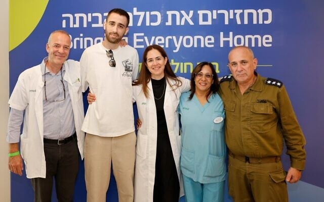 (L-R) Prof. Gil Salsman, head of the mental health care team at the Returned Hostages Unit, freed hostage Avinatan Or,
Prof. Noa Eliakim Raz, director of the unit, Avivit Zetelman, the head nurse at the unit, and Col. Yoav Bar Sela, commander of the hospital's IDF Reception Center on October 21, 2025 (Courtesy/Guy Yechieli) (L-R) Prof. Gil Salsman, head of the mental health care team at the Returned Hostages Unit, freed hostage Avinatan Or,
Prof. Noa Eliakim Raz, director of the unit, Avivit Zetelman, the head nurse at the unit, and Col. Yoav Bar Sela, commander of the hospital's IDF Reception Center on October 21, 2025 (Courtesy/Guy Yechieli)
