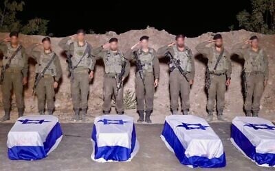 IDF troops salute over the caskets containing the bodies of slain hostages Guy Illouz, Bipin Joshi, Yossi Sharabi and Cpt. Daniel Perez in the Gaza Strip, late October 13, 2025. (Israel Defense Forces)