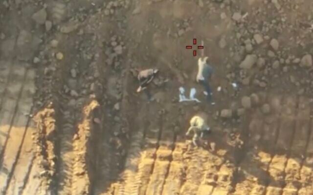 Image from IDF drone footage showing terror operatives staging the recovery of hostage remains on October 27, 2025 (Screen grab)