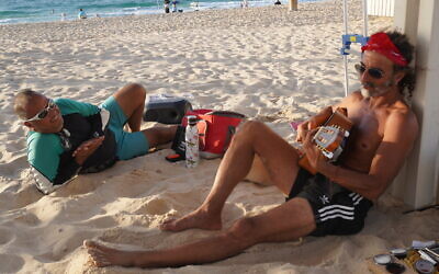 Sderot residents Oren Weizmann (left) and Itzik Abergel (right) while visiting Zikim Beach within a week after the site's reopening, two years after October 7, 2023, massacre on October 21, 2025. (Charlie Summers/Times of Israel)