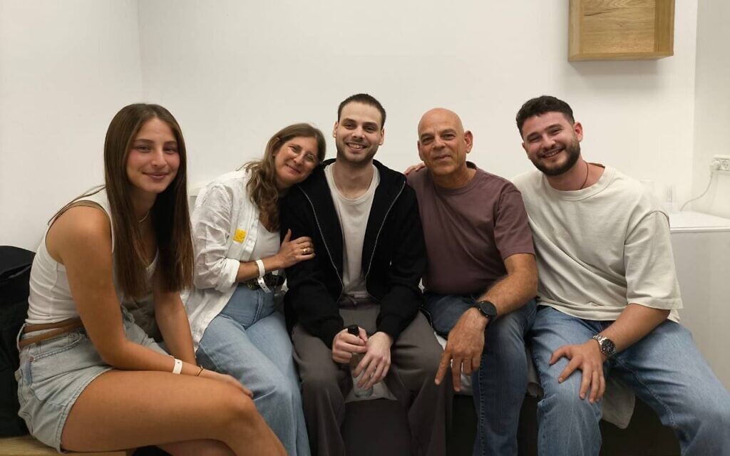 Released hostage Alon Ohel (C) is seen reunited with his family at the IDF's Re'im base after over two years in Hamas captivity on October 13, 2025 (Courtesy)