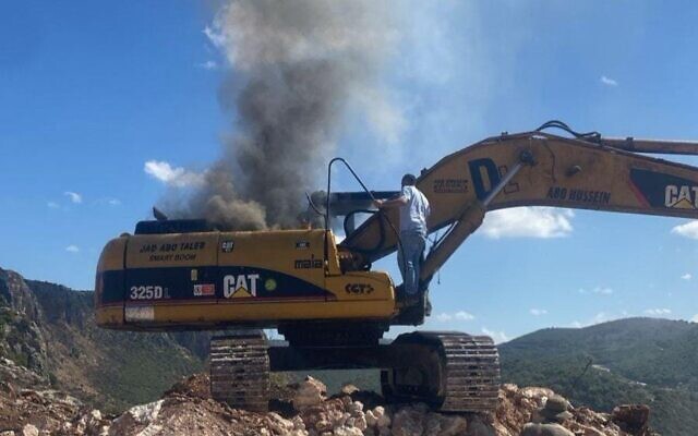 Smoke billows from an excavator after an Israeli strike on a man who the IDF says was trying to restore Hezbollah terrorist infrastructure, between the southern Lebanese towns of Yater and Zinqin, October 7, 2025. (Used in accordance with Clause 27a of the Copyright Law) Smoke billows from an excavator after an Israeli strike on a man who the IDF says was trying to restore Hezbollah terrorist infrastructure, between the southern Lebanese towns of Yater and Zinqin, October 7, 2025. (Used in accordance with Clause 27a of the Copyright Law)