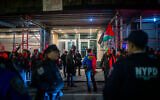 The entrance to Park East Synagogue, with dueling protesters on each side, separated by police, in New York City, November 19, 2025. (Luke Tress/Times of Israel)