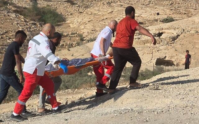 Red Crescent medics carry a Palestinian injured in an apparent settler attack, in the West Bank village of Umm al-Kheir, November 9, 2025. (Umm Al-Kheir Village Council)