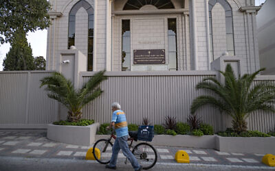 A man pushes a bicycle past the new Syriac Orthodox Mor Ephrem Church on the eve of its official inauguration in Istanbul on October 7, 2023. (YASIN AKGUL / AFP)