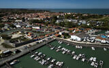 This aerial view shows boats moored in the harbour of Le Chateau-d'Oleron with the city in background, on the Island of Oleron, southwestern France, on April 8, 2025 (Philippe LOPEZ / AFP)