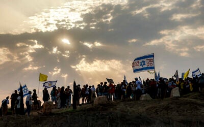 People march with flags calling for an end to the war near Kibbutz Nahal Oz in southern Israel close to the border with the Gaza Strip on August 10, 2025. (Menahem KAHANA / AFP) People march with flags calling for an end to the war near Kibbutz Nahal Oz in southern Israel close to the border with the Gaza Strip on August 10, 2025. (Menahem KAHANA / AFP)