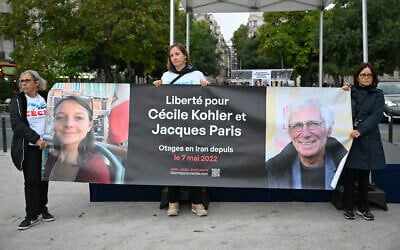 People hold a banner reading "Freedom for Cecile Kohler and Jacques Paris hostages in Iran since May 7, 2022," as they gather to celebrate the 41st birthday of Kohler, held in Iran since May 2022 on spying charges, in Paris, France, on September 25, 2025. (Bertrand GUAY / AFP) People hold a banner reading "Freedom for Cecile Kohler and Jacques Paris hostages in Iran since May 7, 2022," as they gather to celebrate the 41st birthday of Kohler, held in Iran since May 2022 on spying charges, in Paris, France, on September 25, 2025. (Bertrand GUAY / AFP)