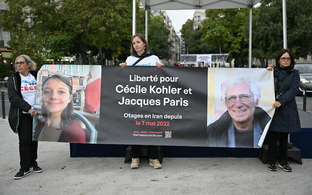 People hold a banner reading "Freedom for Cecile Kohler and Jacques Paris hostages in Iran since May 7, 2022," as they gather to celebrate the 41st birthday of Kohler, held in Iran since May 2022 on spying charges, in Paris, France, on September 25, 2025. (Bertrand GUAY / AFP) People hold a banner reading "Freedom for Cecile Kohler and Jacques Paris hostages in Iran since May 7, 2022," as they gather to celebrate the 41st birthday of Kohler, held in Iran since May 2022 on spying charges, in Paris, France, on September 25, 2025. (Bertrand GUAY / AFP)