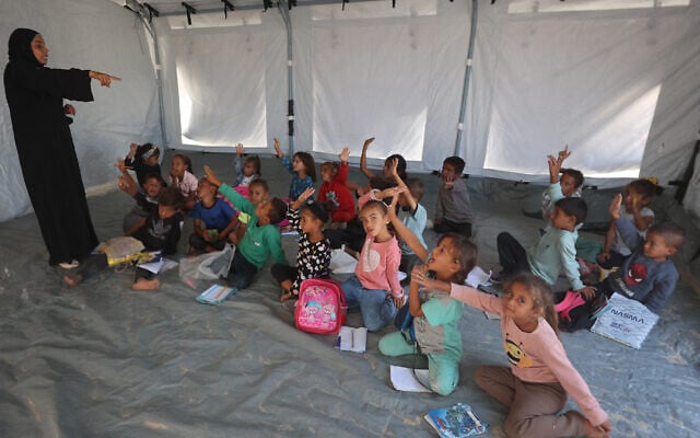 Palestinian pupils attend a class at a school set up by the Mayasem Association for Culture with UNICEF support, at a displacement camp in the area of Khan Younis. October 7, 2025.(Photo by Omar AL-QATTAA / AFP)