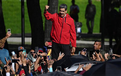 Venezuela's President Nicolas Maduro waves to supporters during a march to commemorate the 'Day of Indigenous Resistance' in the capital Caracas on October 12, 2025. (Federico PARRA / AFP)