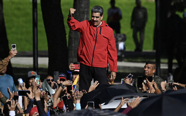 Venezuela's President Nicolas Maduro waves to supporters during a march to commemorate the 'Day of Indigenous Resistance' in the capital Caracas on October 12, 2025. (Federico PARRA / AFP)