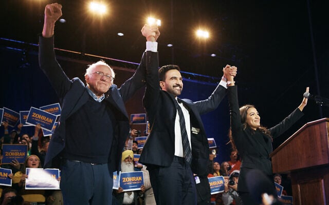 New York mayoral candidate Zohran Mamdani, center, celebrates with US Senator Bernie Sanders, left, and US Representative Alexandria Ocasio-Cortez, right, during an election rally on October 26, 2025, at Forest Hills Stadium in the Queens borough of New York City. (Andres Kudacki/Getty Images/AFP)