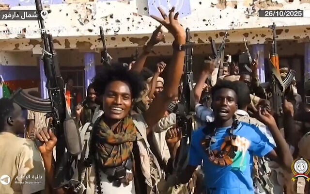 This image grab taken from handout video footage released on Sudan's paramilitary Rapid Support Forces (RSF) Telegram account on October 26, 2025, shows RSF fighters holding weapons and celebrating in the streets of El-Fasher in Sudan's Darfur (Rapid Support Forces (RSF) / AFP)