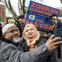 Supporters of Democratic New York City mayoral candidate Zohran Mamdani pose for a selfie during a campaign event on November 1, 2025, in the Queens borough of New York City. (STEPHANIE KEITH / GETTY IMAGES NORTH AMERICA / Getty Images via AFP)