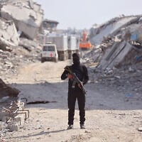 Illustrative: An armed Palestinian Hamas gunman stand not far from an International Red Cross (ICRC) vehicle, as a search for the bodies of killed Israeli hostages takes place, in Gaza City on November 2, 2025. (Omar AL-QATTAA / AFP)