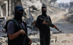 Armed Hamas members are seen guarding an area in Gaza City on November 3, 2025. (Omar AL-QATTAA / AFP)