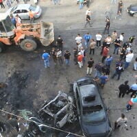 People gather at the site of an Israeli drone strike that targeted a vehicle in the southern Lebanese village of Doueir near the city of Nabatiyeh, on November 3, 2025. (Mahmoud ZAYYAT / AFP)