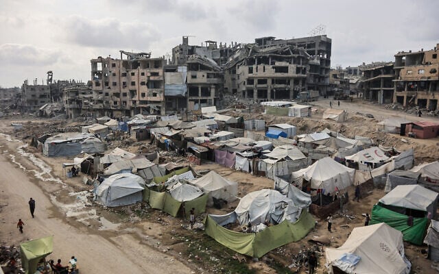 Palestinians walk around their tents in Gaza City on November 3, 2025. (Omar AL-QATTAA / AFP)