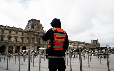 A private security guard patrols in the courtyard of the Louvre museum, in Paris on November 3, 2025. (Julie SEBADELHA / AFP)