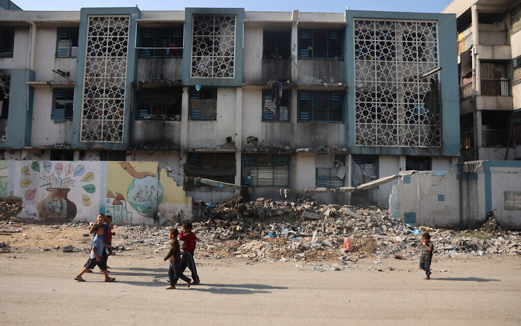 Children walk near a camp for displaced Palestinians at a school-turned-shelter in Al-Rimal neighborhood of Gaza City on November 5, 2025. (Omar Al-Qattaa/AFP) Children walk near a camp for displaced Palestinians at a school-turned-shelter in Al-Rimal neighborhood of Gaza City on November 5, 2025. (Omar Al-Qattaa/AFP)