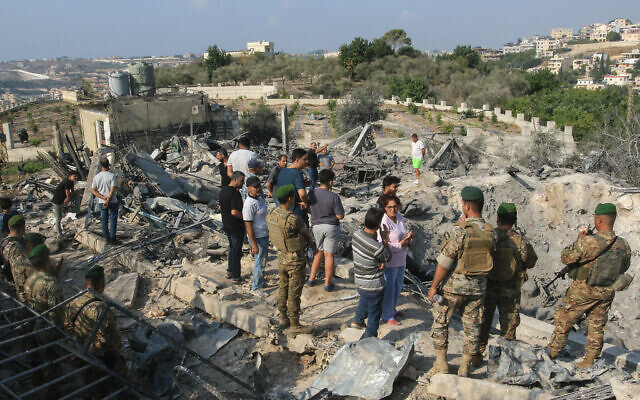 Lebanese soldiers and local residents stand at the site of an Israeli airstrike in the southern Lebanese village of Toura on November 6, 2025. (Mahmoud Zayyat / AFP) Lebanese soldiers and local residents stand at the site of an Israeli airstrike in the southern Lebanese village of Toura on November 6, 2025. (Mahmoud Zayyat / AFP)