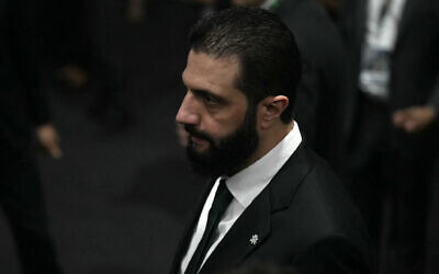 Syria's President Ahmed al-Sharaa walks on arrival at the General Plenary of Leaders in the framework of the COP30 UN Climate Change Conference in Belem, Para State, Brazil, on November 6, 2025. (Mauro PIMENTEL / AFP)